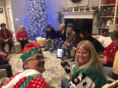 Team members beside the Christmas tree