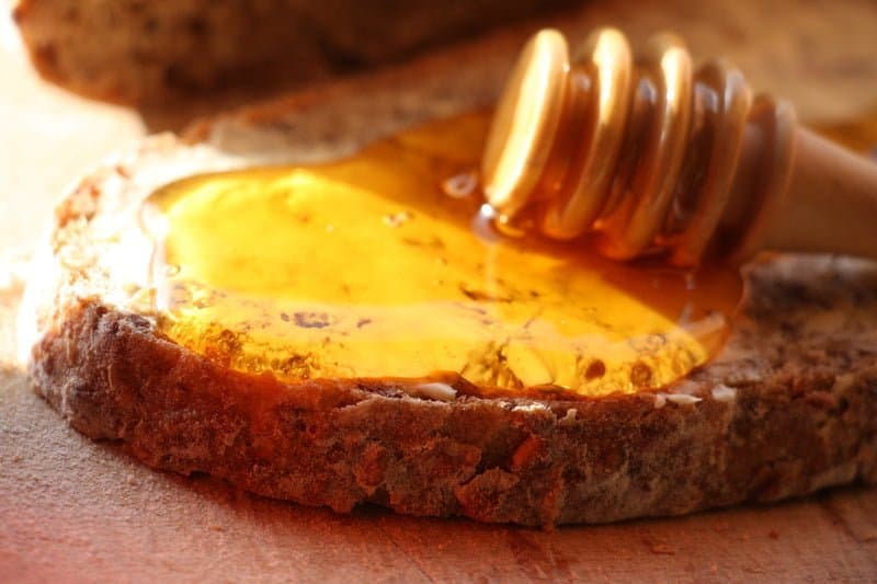 Honey drizzled over a slice of bread
