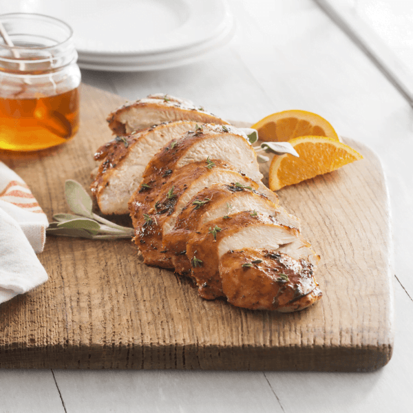 Turkey breast carved on a board with honey