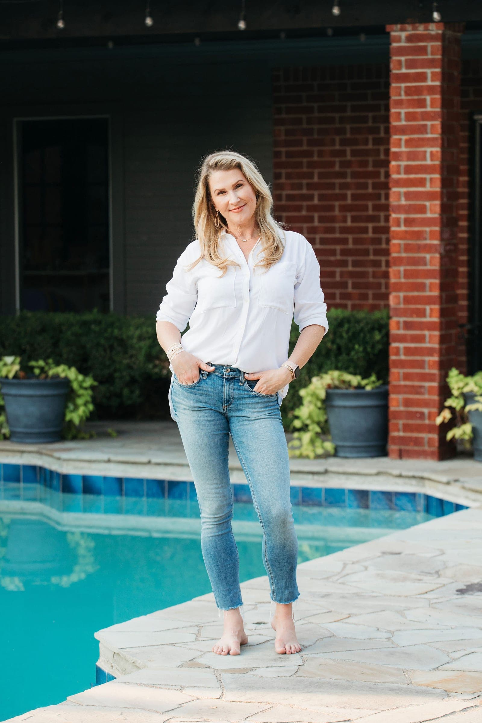 Portrait of the owner outside her home