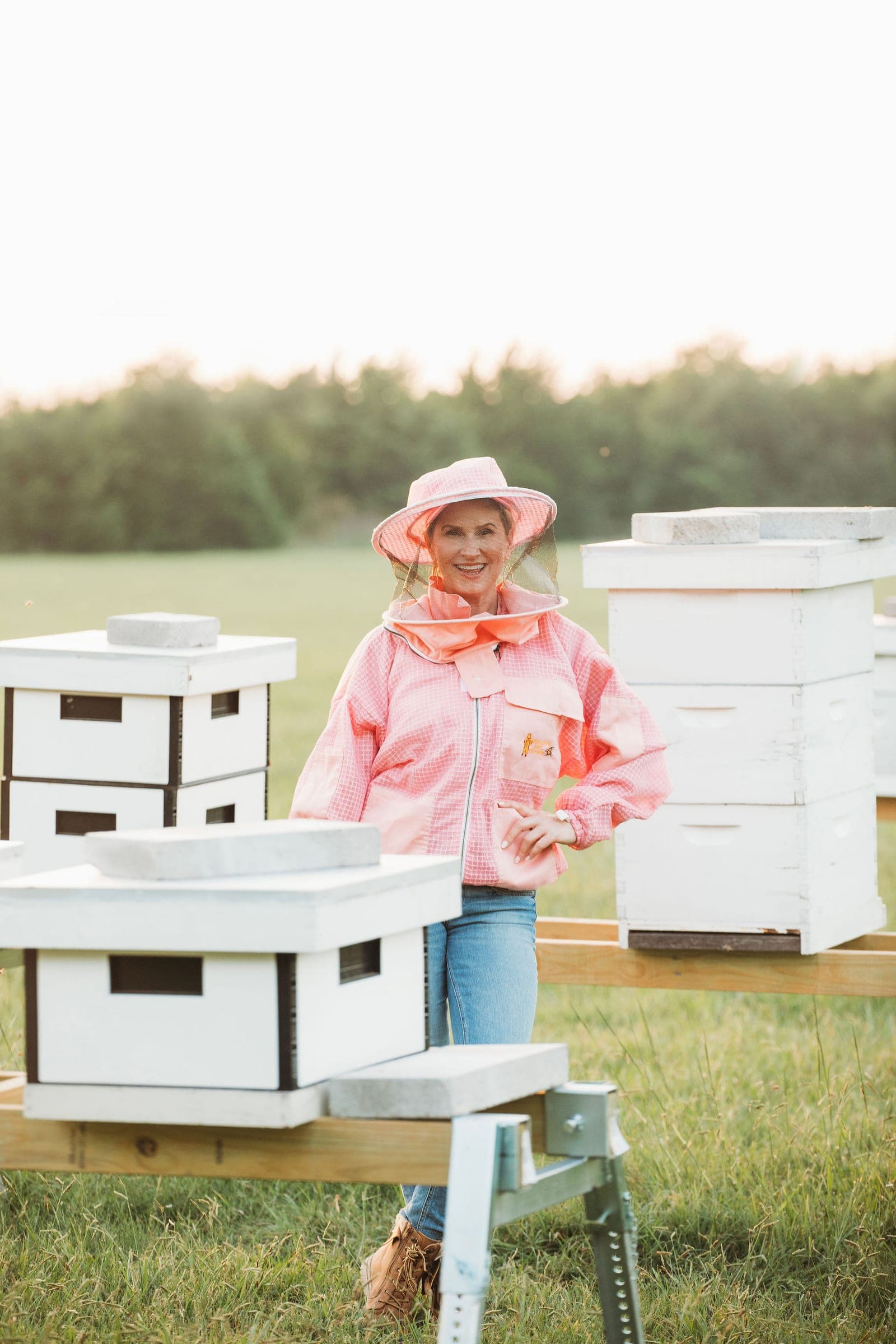 A beekeeper standing among the hives