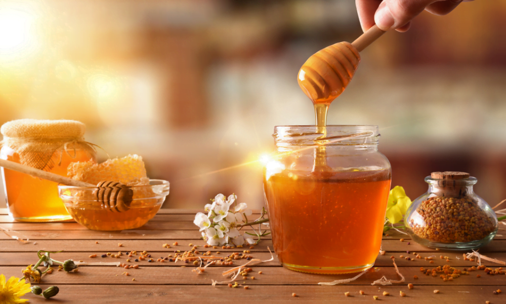 Honey being drizzled into a pot